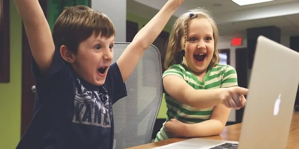 Kids excited around computer